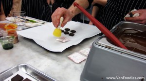 Stamp the transfer sheet onto the chocolate